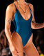 A model wearing a blue one-piece swimsuit with a deep neckline and high-cut design.