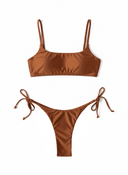 Brown bikini set with thin straps and tied sides on a white background